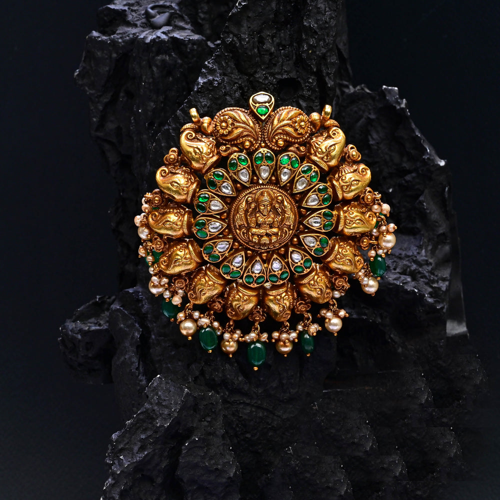 Premium 92.5 silver temple pendant featuring traditional Lakshmi motif, kemp stones, antique finish and intricate handcrafted South Indian design by Sri Fine Jewellery, Hyderabad.
(https://www.srifinejewellery.com)