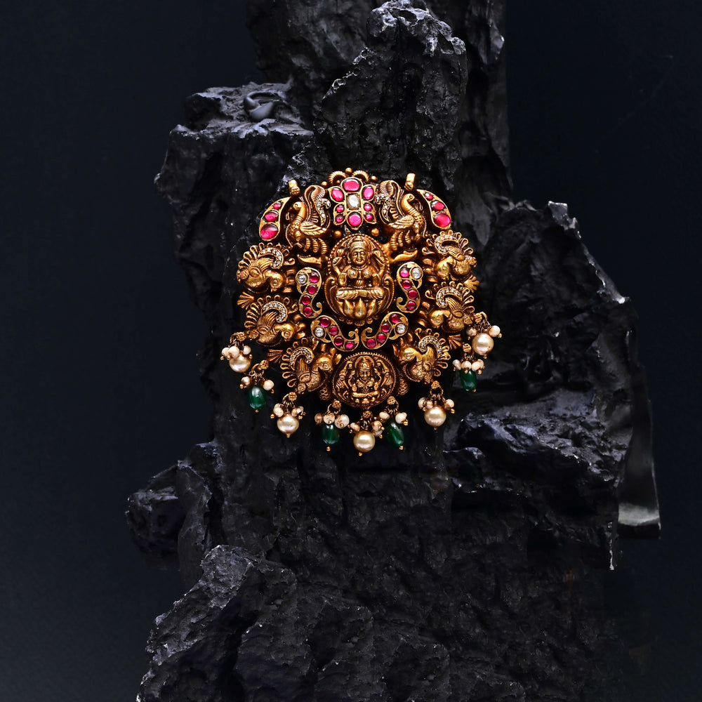 Premium 92.5 silver temple pendant featuring traditional Lakshmi motif, kemp stones, antique finish and intricate handcrafted South Indian design by Sri Fine Jewellery, Hyderabad.
(https://www.srifinejewellery.com)