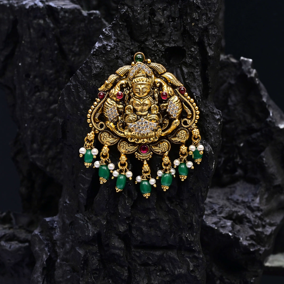 Premium 92.5 silver temple pendant featuring traditional Lakshmi motif, kemp stones, antique finish and intricate handcrafted South Indian design by Sri Fine Jewellery, Hyderabad.
(https://www.srifinejewellery.com)