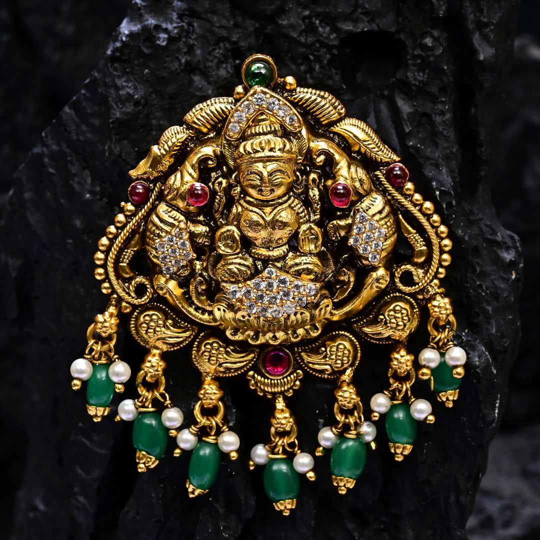 Premium 92.5 silver temple pendant featuring traditional Lakshmi motif, kemp stones, antique finish and intricate handcrafted South Indian design by Sri Fine Jewellery, Hyderabad.
(https://www.srifinejewellery.com)
