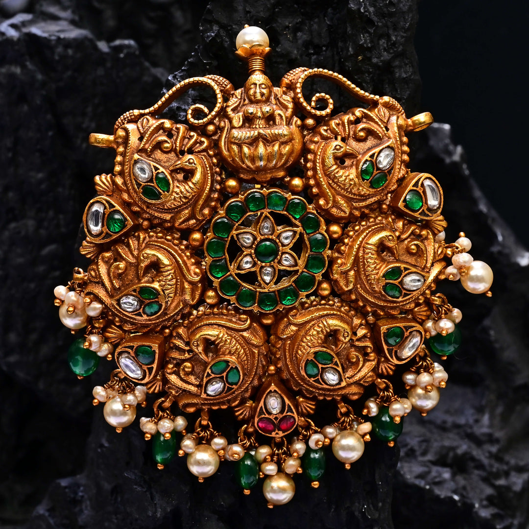 Premium 92.5 silver temple pendant featuring traditional emerald kemp stones, Lakshmi motif, antique finish, and intricate handcrafted South Indian design by Sri Fine Jewellery, Hyderabad.
(https://www.srifinejewellery.com)